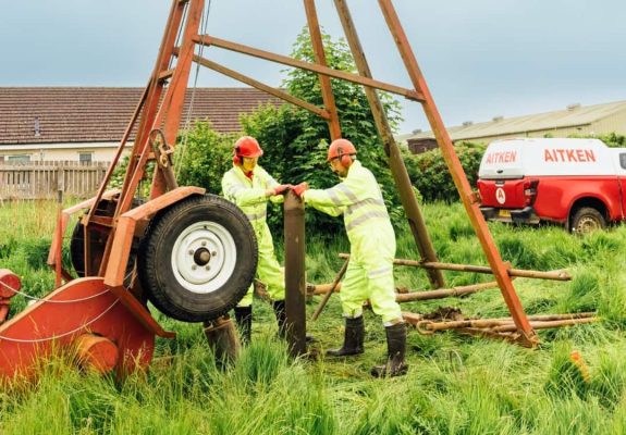 Aitken Labs ground investigation engineers operating a drilling rig onsite.