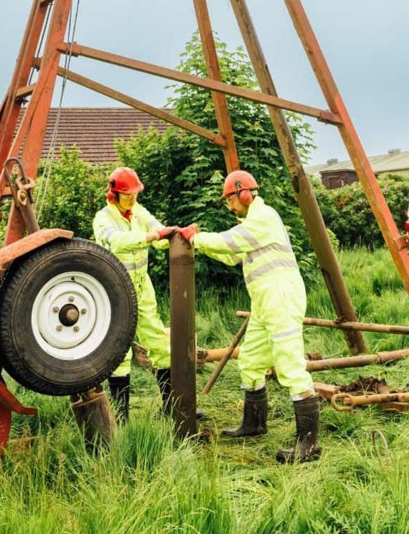 Aitken Labs ground investigation engineers operating a drilling rig onsite.