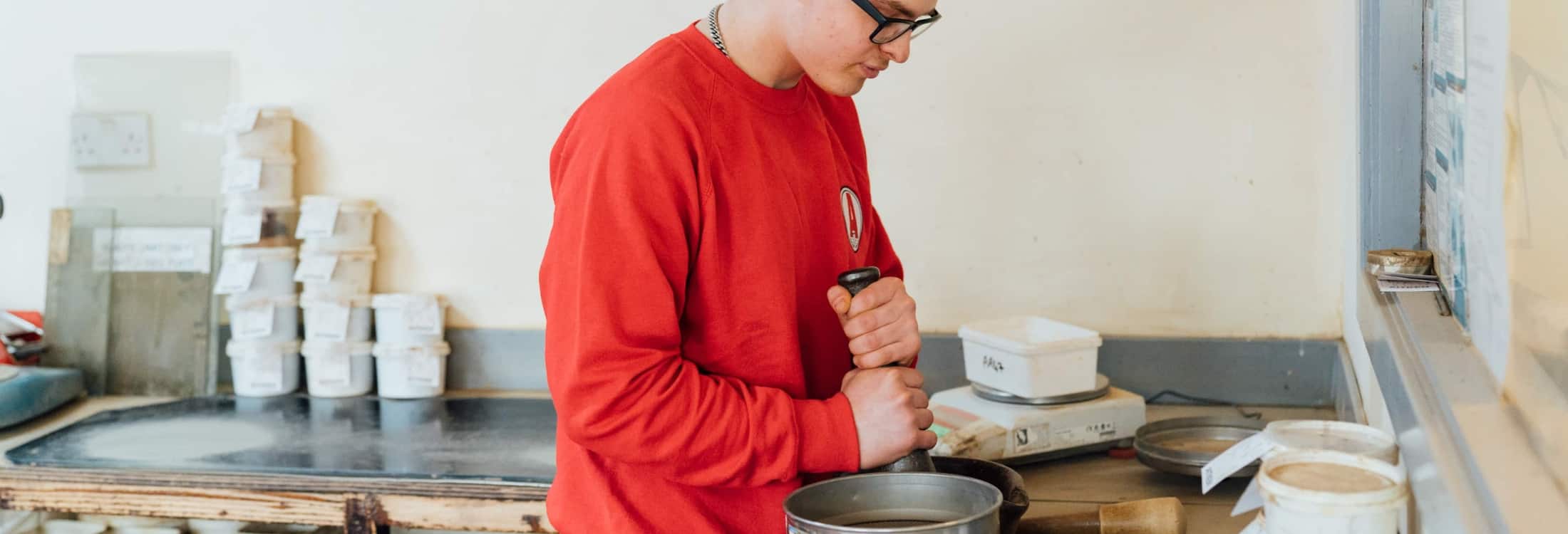 Aitken Labs technician preparing soil samples for geotechnical laboratory testing.