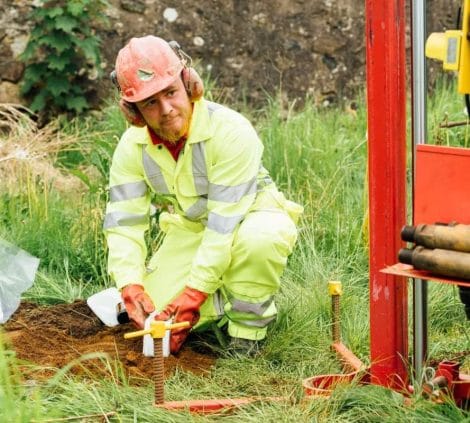 Aitken Labs engineer collecting soil samples for geotechnical site investigation