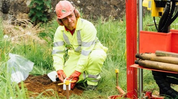 Aitken Labs engineer collecting soil samples for geotechnical site investigation
